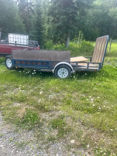 This 16-foot utility trailer is a reliable workhorse featuring a durable steel frame, wooden sides,...