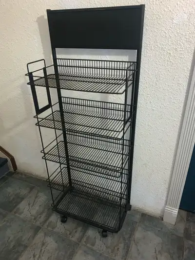 Black metal storage rack on wheels . 5 shelves. does not come apart. very solid and can hold a lot o...