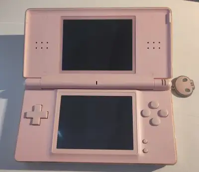 Lightly used Pink DS Lite with Kuromi skull charm. Screens are in excellent condition, buttons are s...