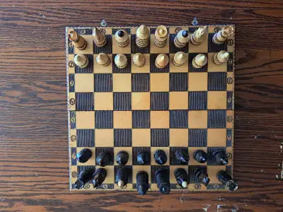 A vintage hand carved wooden folding chess set. Complete set. Eastern European origins. Excellent sh...
