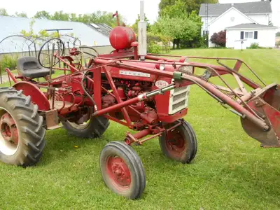 1961 Farmall 140 with complete set of cultivators, plus front end blade, Henderson trip-bucket loade...