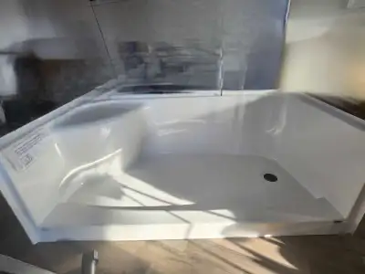 This shower base with a built-in seat is a practical addition to any bathroom. New never been used,...