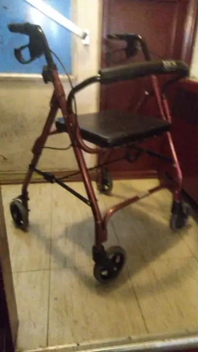 This pre-owned Drive Medical four-wheeled rollator provides reliable support and mobility assistance...