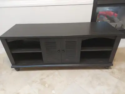 TV bench. Exc. Condition. 2 doors, 4 shelves, walnut tone. 63 ins . L. X 21 ins. W. x 26. ins. H