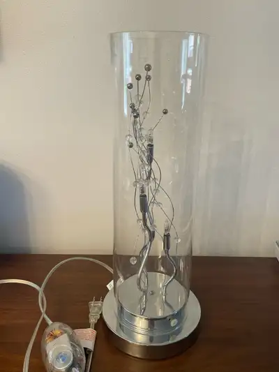 Illuminate your living space with this stylish Structube lamp featuring a sleek glass cylinder desig...