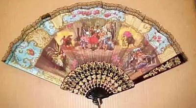 THIS IS A LARGE AND VERY DECORATIVE FAN. IT IS 13 INCHES IN LENGTH AND OPENS TO 24 INCHES IN WIDTH....
