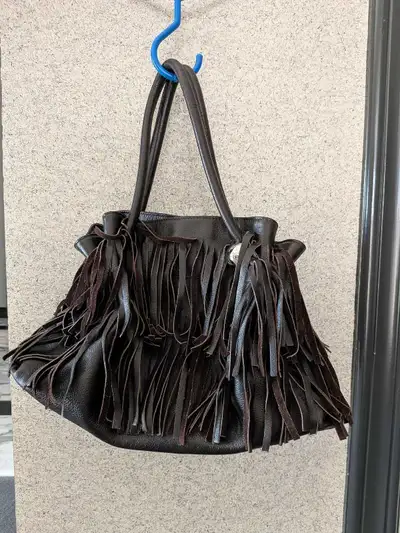 Selling a used Furla leather fringe handbag. Cash only. Pickup at Bayview Hill Community Center.