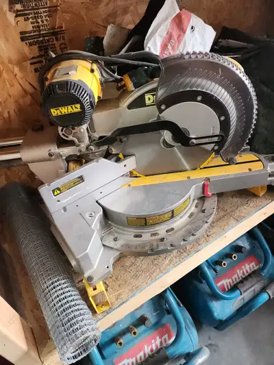 Dewalt 15 amp 12" compound sliding miter saw and stand. Call or text Ian 780 718-5895