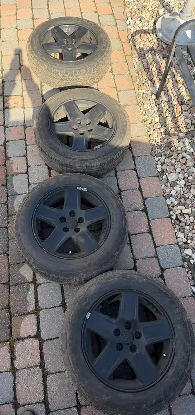 I am selling a set of four used Dodge rims with tires , each measuring 215/65R17. These rims are in...