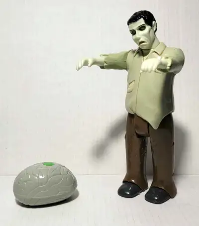 Approx 8 inch tall. comes with brain remote. works press the button and he makes growling sounds and...