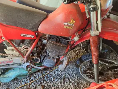 This is a Honda Elsinore CR, a vintage motocross bike, perfect for collectors or restoration enthusi...