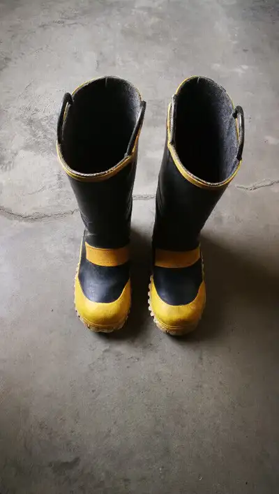 Rubber work boot and work glove and hard hat, View more