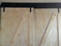 Large custom-made solid wood barn doors and mounting equipment
