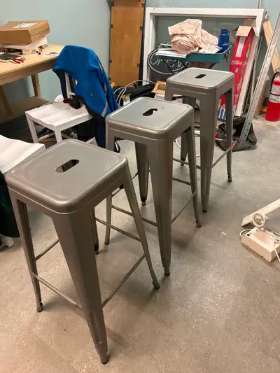 3 stackable grey metal bar stools, View more