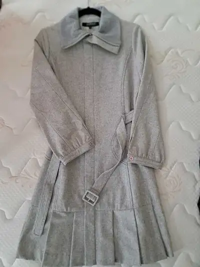 Grey wool blend coat. Long sleeves, belted waist, pleated hem. Size not specified. Dry clean only.