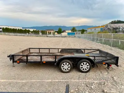 Features: • 7,000 lb GVWR, dual axles, solid wood deck • Massive 16’ x 7’ wood deck, honest wear but...