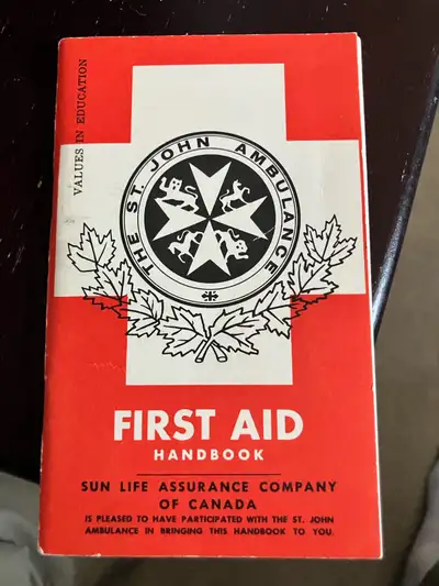 This vintage, pocket-sized St. John Ambulance First Aid Handbook, published in 1965 in partnership w...