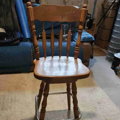 This is a sturdy wooden bar stool that's perfect for adding a touch of rustic charm to your kitchen...