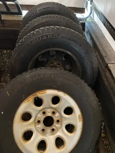 For sale is a set of four 265-70R-17 winter tires mounted on GMC rims, offering reliable traction an...