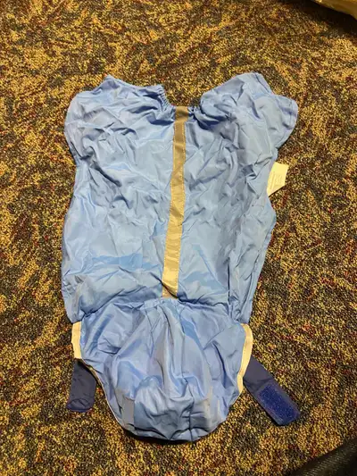 Blue dog raincoat with a hood and velcro closures. Size small. Can be rolled up into a pouch Major i...