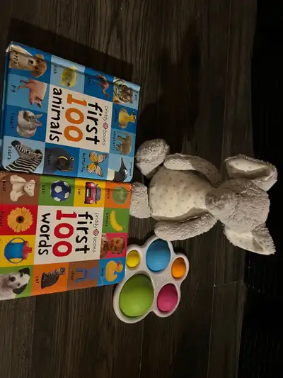 Jellycat elephant rattle, two books and a popper. All in great condition. $10 Pickup in west Edmonto...