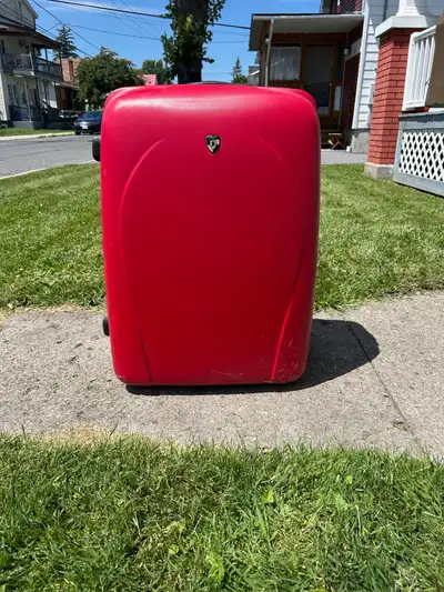 Large 31” red hard sided luggage with wheels. Built to last and in excellent condition. No stains, m...