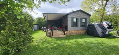 This pre-owned park model trailer offers a spacious and comfortable living environment, perfect for...
