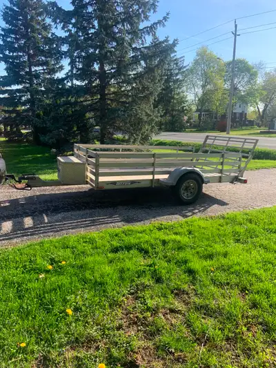 2006 Triton aluminum utility trailer with optional sides and rear ramp. 2000 lb Dexter torsion axle....