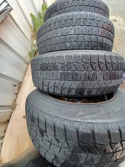 Bridgestone BLIZZAK 195/65R 15s On volvo rims. Pretty good tread left. Gotta get them outta here.