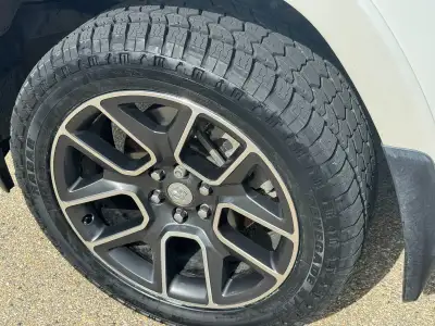 Set of factory 22" rims with nearly new tires purchased in July 2025 and driven less than 2,000 km....