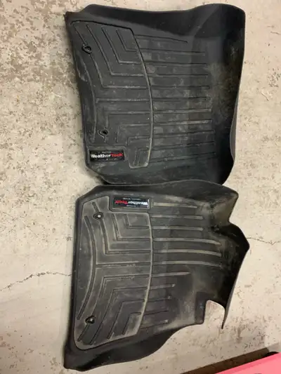 These are used Weather Tech floor mats designed specifically for a BMW 335i, offering superior prote...