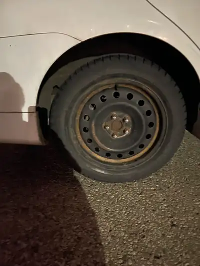 This is a used tire on a steel rim, perfect as a spare or replacement. The tire shows signs of wear,...