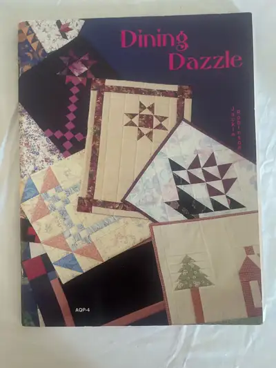 Explore your creative side with "Dining Dazzle" by Jackie Robinson, a book filled with quilting proj...