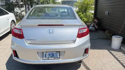 Sleek silver Honda Accord two-door coupe. This vehicle has alloy wheels, a sunroof, and a single exh...