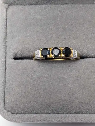 Brand new gold rhodium plated ring featuring five deep blue sapphires accented by white topaz. Craft...