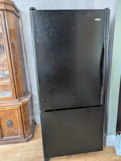 Black Amana 30 inch refrigerator with freezer on the bottom. We have been using it for years with no...