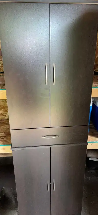 Sturdy, large, tall, dark brown storage cabinet. Great condition. Two sets of double doors with a sh...