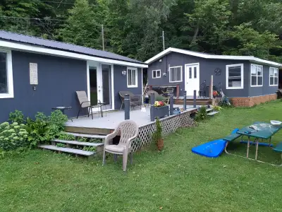 This lovely cottage features two cabins and a bunkie on Irvine Bay on Wolfe Island. Sand shore, idea...