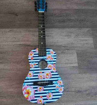 Blue and black guitar with beautiful pink flowers 