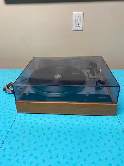 This vintage Thorens TD160 turntable features an Ortofon M15 Super cartridge and a solid hardwood pl...