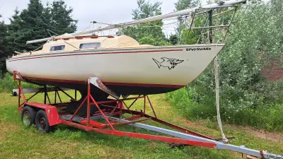 C&C Shark 24 with dual axle trailer and 6 HP Outboard Motor. Two rudders and two full sets of sails.