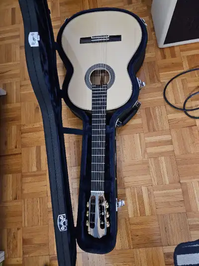 The 45 Limited is handcrafted in Spain with a solid European spruce top and black and white ebony ba...