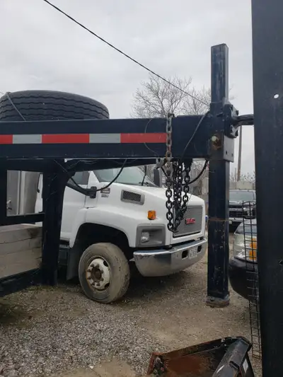 Excellent condition, great for skid steers, mini ex, material. Removable storage area. Solid trailer...