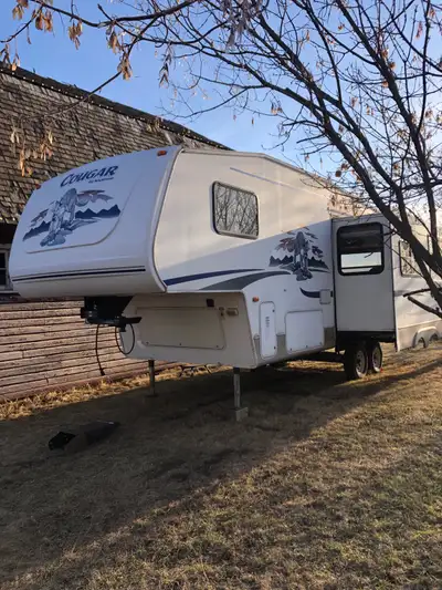 Rear kitchen, one large slide. Same owners for 19 years. Some camping supplies included. New batteri...