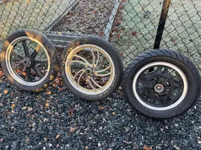 Three street bike rims and tires. 16inch has a brand new tire never used on it, the other two rims a...