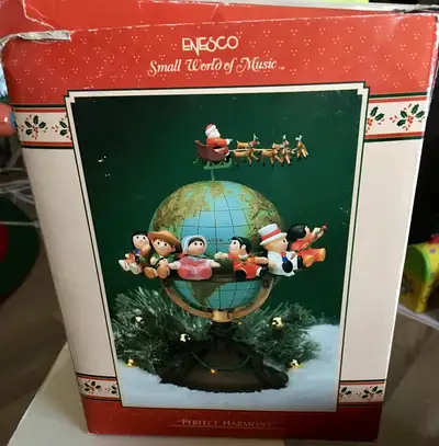 This is for a ENESCO Small World of Music Perfect Harmony Music Box dated 1990. It is in box with st...