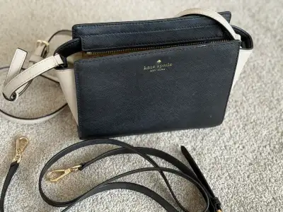 Kate Spade shoulder bag featuring a black and beige colour block design. The bag includes 2 detachab...