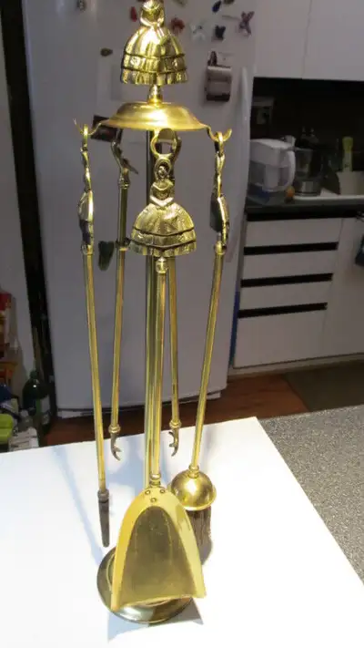 Antique brass fireplace tool set., View more