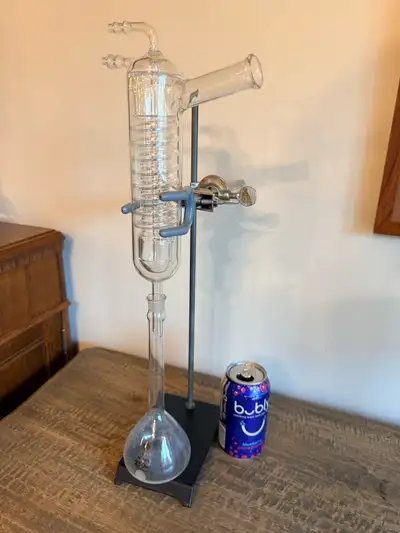 Authentic vintage laboratory chemistry apparatus featuring PYREX scientific glassware, spiral conden...