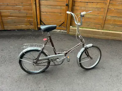 Vintage folding 3 speed Bicycle. Needs new rear tube for tire. Comes with kick stand and rear carrie...
